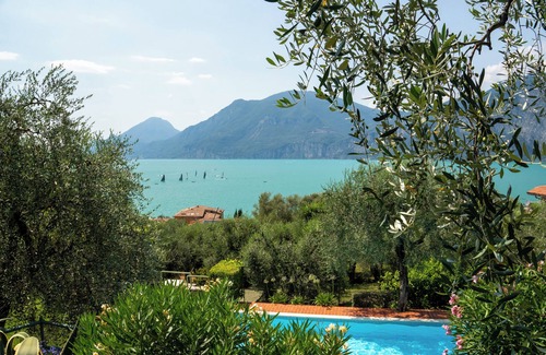 Assenza Apartment | Wonderful balcony on the lake with beautiful pool and garden among palm and olive trees