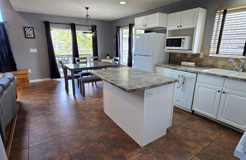 Marion House | Lake Front home Sleeps 10 Overlooking deck for perfect lake views & a coffee bar