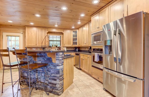 Copperhill Cabin | Pond-front cabin with private hot tub, fireplaces, furnished deck, & game room