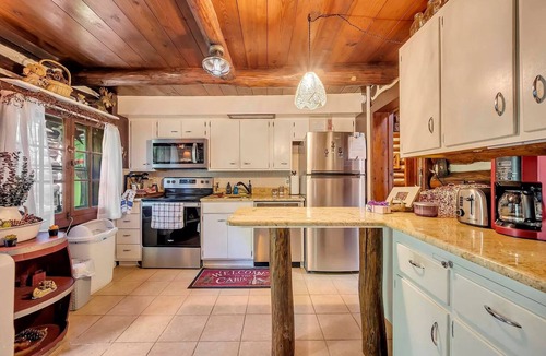 East Stroudsburg Cabin | Rustic Rest Log Cabin, with hot tub and stream, near Poconos attractions.
