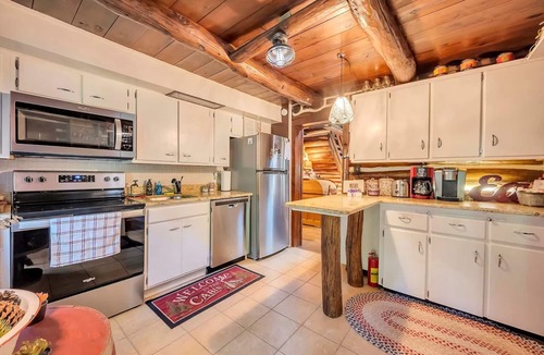 East Stroudsburg Cabin | Rustic Rest Log Cabin, with hot tub and stream, near Poconos attractions.
