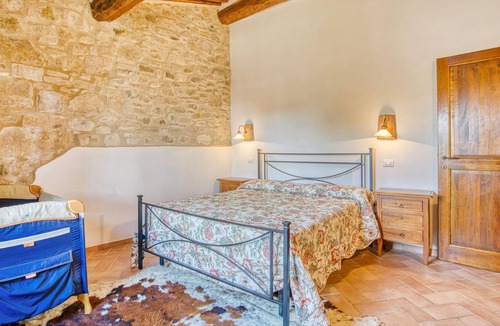 Radicondoli Apartment | Welcome to this charming stone house with shared pool and panoramic views of beautiful surroundings.