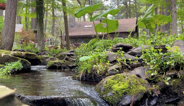 Rustic Rest Log Cabin, with hot tub and stream, near Poconos attractions.